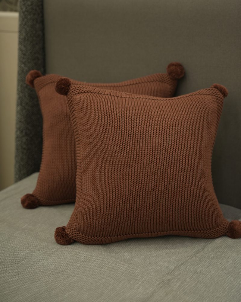 Textured cushions and throws on a sofa at Drape Shoppe
