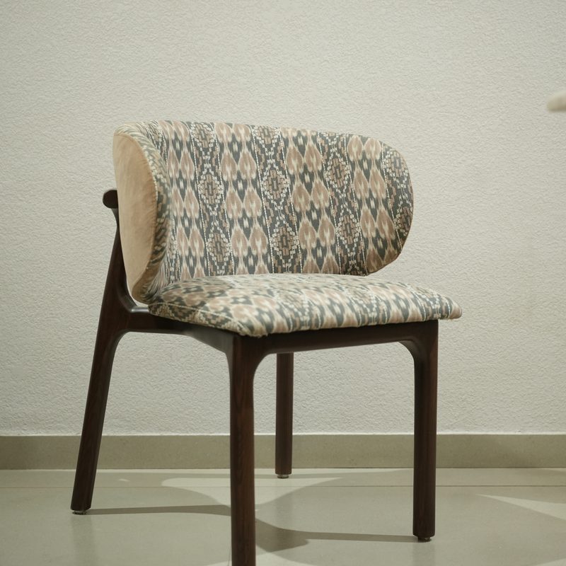 Curved-back dining chair in patterned upholstery at Drape Shoppe